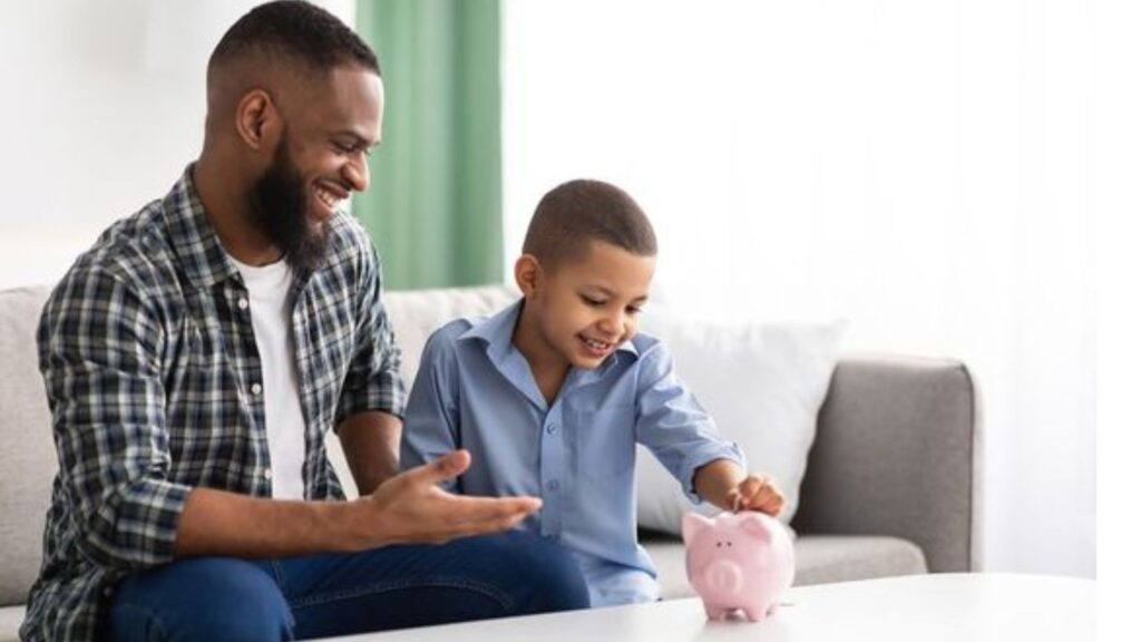 Father showing his son saving using piggy bank